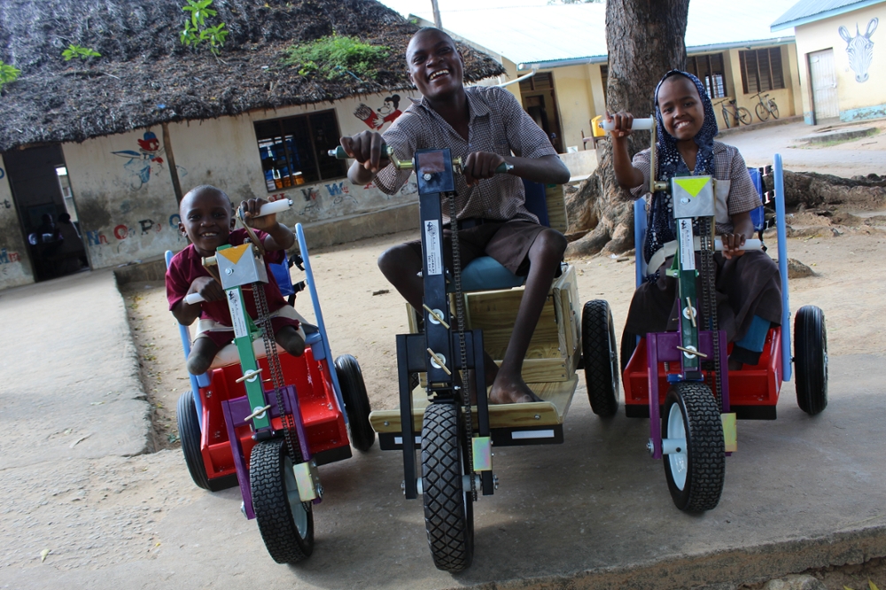 Patients in Kenya smile after receiving Mobility Carts donated by MedShare. (Courtesy Medshare)